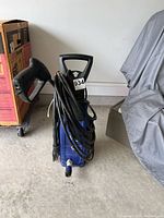 Front view of pressure washer with hose and spray gun