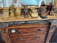 Full view of six pairs of bookends on dresser