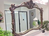 Full front view of ornate frame with mirror