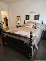 Full view of queen bed frame with bedding