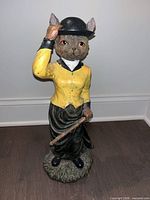 Full view of anthropomorphic fox figurine showing attire and posture