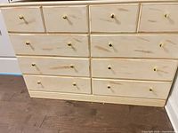 front view showing all 10 drawers and brass knobs
