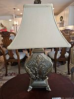 Front view of complete lamp showing base, shade, finial