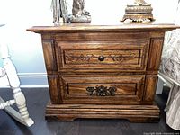 Front view of nightstand showing closed drawers and hardware