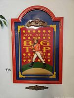 Full view of arched circus wall plaque with figure, frame and top applique