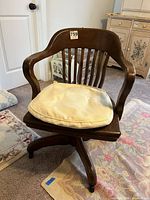 Front view of oak swivel desk chair with cushion