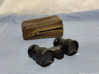 Front view of Narel opera glasses and brown leather case
