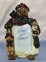 Front view of carved resin bear photo frame with 4×6 insert