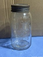 Front view of clear Crown Imperial jar showing embossing and lid