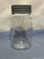 Front view of jar showing Crown embossing and metal band