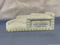 Front view showing printed collection name, floral border and two-tier structure