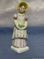 Front view of Emma figurine showing attire and base