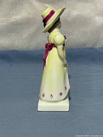 Right side profile showing dress, hat and bow