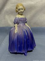Front view of Royal Doulton Marie figurine showing face, bodice and gradient purple gown