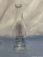 Full upright view showing jar shape, neck, cap