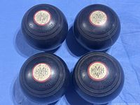 Group of four Brunswick Mineralite lawn bowls numbered 1-4