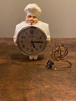 Front view of chef clock with cord and plug visible