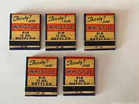 Front view of five Whistle matchbooks showing primary graphics