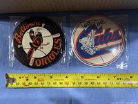 Both buttons with ruler showing ~6 in. diameter