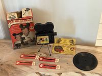 Full lot showing projector, box, record, film strips, booklet