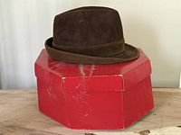 Hat resting on closed red octagonal box