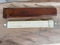 Slide rule and leather case full view