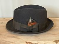 Front side view of fedora showing ribbon and feather