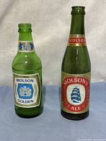 Front view of both Molson bottles showing labels and size difference