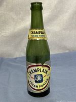 Front view of green glass bottle with labels visible