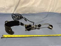 Full view of headset laid flat with measuring tape