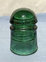 Front view of green Brookfield insulator