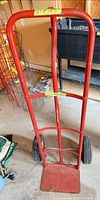 Front view of red steel two-wheel hand truck dolly
