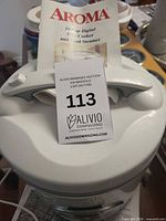 Top view of Aroma rice cooker with manual on lid