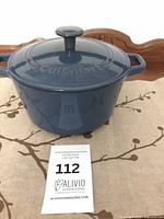 Dutch oven with lid on, showing blue exterior and embossed logo