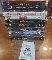 Stack of ten DVD and Blu-ray movie cases showing spines
