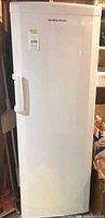 Front view of white Hamilton Beach upright freezer with door and handle visible