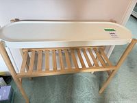 Full view of IKEA SATSUMAS plant stand, top tray and lower slatted shelf visible