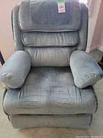 Front view of blue-green fabric La-Z-Boy recliner chair with padded arms and split backrest