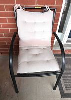 Full view of chair showing frame, cushion, arms