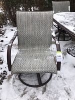 Front view of one chair showing sling fabric and armrests