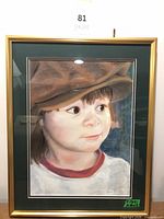 Full view of framed pastel portrait with gold frame and green mat, lot number visible