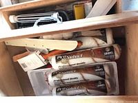 Drawer showing multiple Simms roller covers, paint edger pad, plastic liner, wood stick