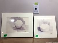 Both matted drawings side by side