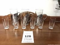 Front view of all three coffee mugs with stainless sleeves and six shot glasses