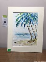 Full view of matted watercolor painting on tabletop