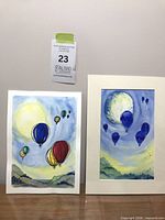 Both paintings side by side showing relative sizes and framing