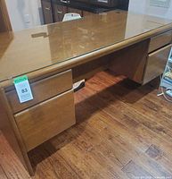 overall view of wooden desk with glass top