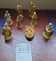 All eight Depose Italy nativity figurines arranged with size tag
