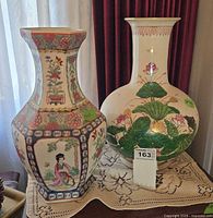 Both vases side by side on table showing overall size and decoration