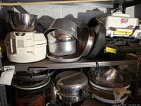 Shelf view showing assorted kitchen appliances and cookware